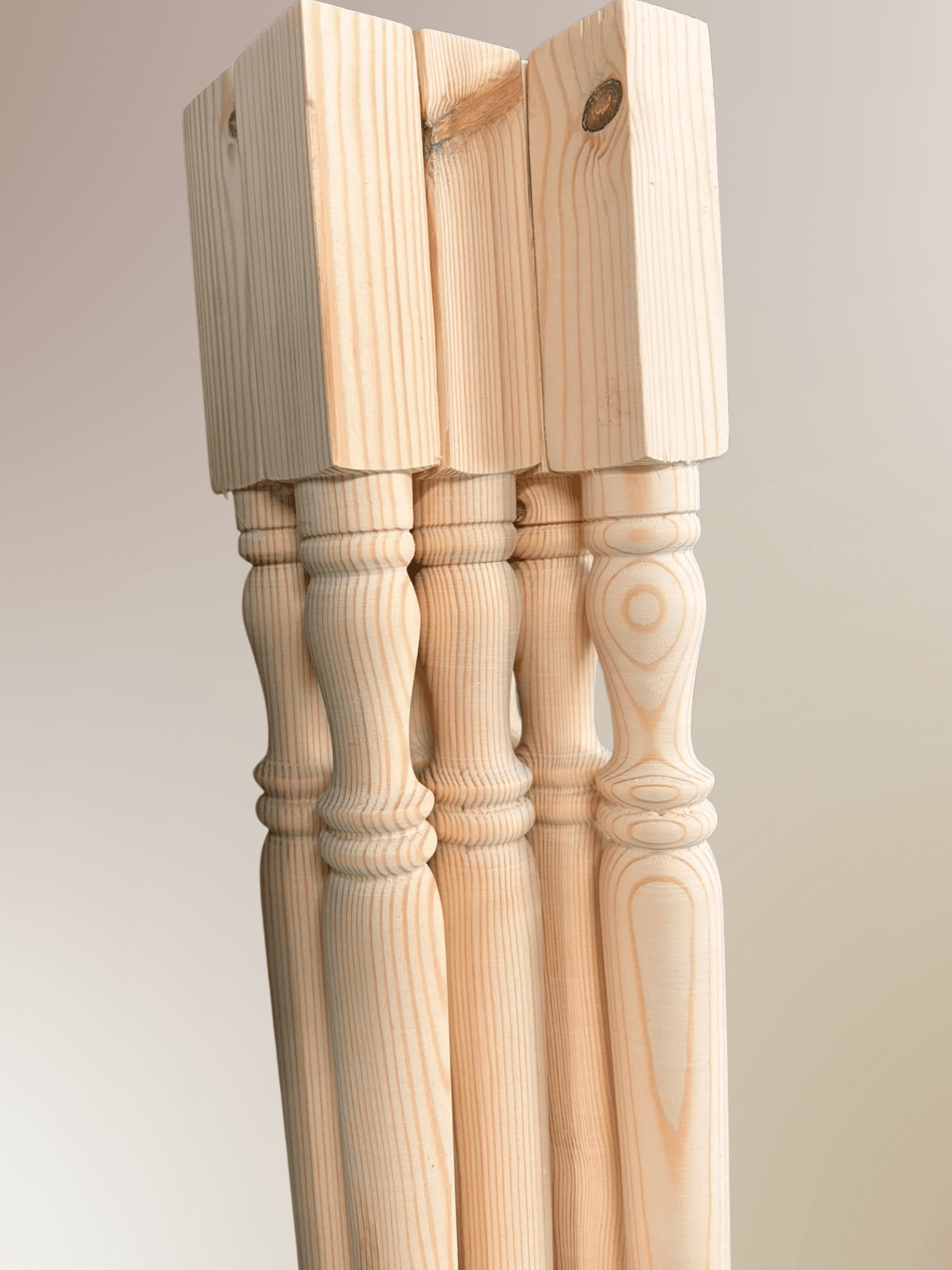 Pine staircase spindles with square top blocks and classic turned vase profile, hand-turned at Spindles Woodturning